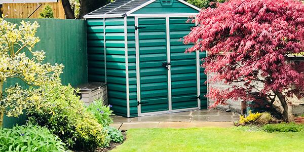 backyard garden shed with trees and landscape